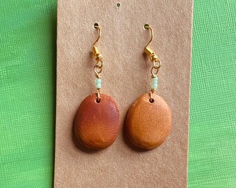 Carved avocado pit earrings. Handmade dangle earrings. Natural jewelry.