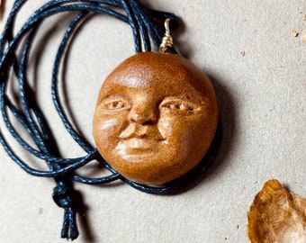 Hand carved avocado pit pendant necklace .  Moon face. Full Moon. Celestial jewelry.