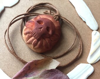 Hand carved avocado pit necklace with a skull. Unique, beautiful, natural. Sugar skull.