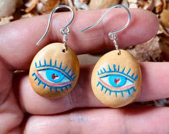 Carved avocado pit earrings with evil eye. Lightweight dangle earrings.
