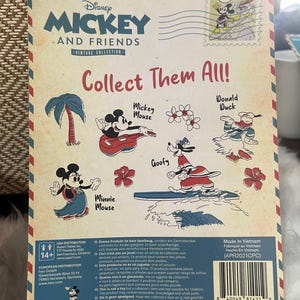 May include: Vintage Disney Mickey and Friends collectible packaging. The back of the package features illustrations of Mickey Mouse, Minnie Mouse, Donald Duck, and Goofy surfing. The packaging has a vintage aesthetic with a postage stamp design.
