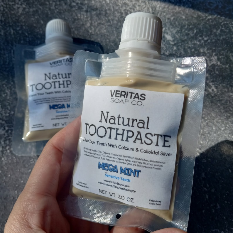 May include: Two pouches of Veritas Soap Co. natural toothpaste. The pouches are clear with white labels. The labels read "Natural Toothpaste" and "Mega Mint for Sensitive Teeth." Each pouch contains 2.0 oz of toothpaste.