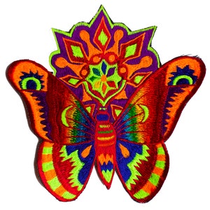 May include: Embroidered butterfly patch with vibrant colors. The butterfly features red, orange, blue, and green wings with intricate detailing. A purple and orange floral design is behind the butterfly, creating a striking contrast. The patch is suitable for clothing or accessories.