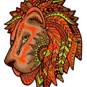 May include: Embroidered lion head in profile, featuring a detailed design with orange, brown, and yellow accents. The mane and facial details are intricately patterned, with a focus on texture and color. The lion has a green eye and a detailed design.