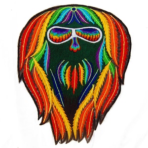 May include: Embroidered patch depicting a face with rainbow sunglasses and a beard of feathers. The patch has a dark green background and a black border. The feathers are in shades of red, orange, yellow, green, blue, and purple.