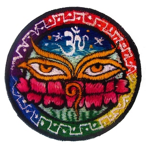 May include: Embroidered patch featuring a colorful design with a central eye motif, surrounded by a rainbow border. The patch includes the Om symbol and a lotus flower, with vibrant hues of orange, pink, blue, and green.
