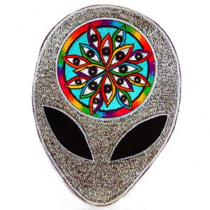 May include: A silver glitter alien head patch with a colorful embroidered eye mandala in the center.