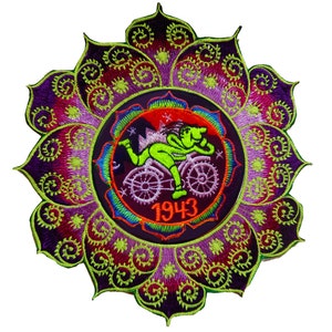 May include: A green figure riding a bicycle with a purple, red, and blue mandala design around it. The year 1943 is printed in orange below the figure.