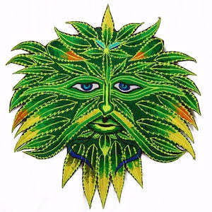 May include: Embroidered patch depicting a Green Man face. The patch is predominantly green, with yellow, orange, and blue accents. The face has a beard and leafy hair. The eyes are blue, and the design is highly detailed.