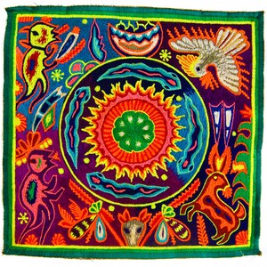 May include: A colorful embroidered textile with a central sun design surrounded by stylized animals and plants. The textile is framed with a green border.
