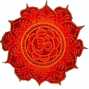 May include: Embroidered patch featuring a vibrant red and orange lotus flower design. The patch has a detailed, circular pattern with an Om symbol at the center. The design is set against a white background.