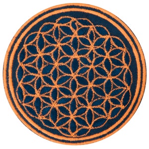 May include: Circular embroidered patch with a flower of life design. The patch has a navy blue background with a golden-orange flower pattern and border. The design is stitched with a zig-zag stitch.