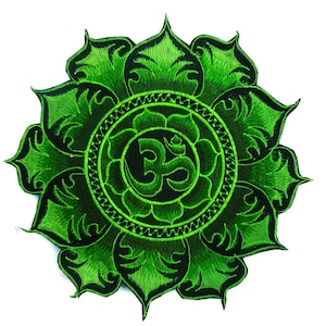 May include: Embroidered patch featuring a green lotus flower design with a black Om symbol at the center. The patch has a detailed, textured appearance with a white background. The patch is likely for clothing or accessories.