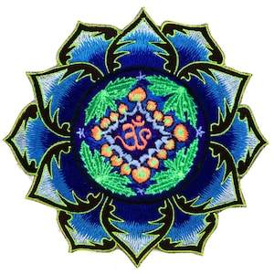 May include: Embroidered patch featuring a blue lotus flower design with a central mandala. The mandala includes the Om symbol in orange, surrounded by green leaves and orange accents. The patch has a black border and a white background.
