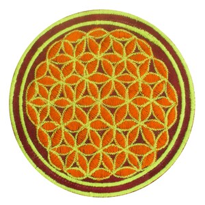 May include: Round embroidered patch featuring a geometric flower of life design. The patch has a dark red border with a light green and dark red trim. The flower of life pattern is orange with light green stitching.