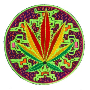 May include: Circular embroidered patch with a cannabis leaf design. The leaf is in red, yellow, and green, set against a neon green and purple circular background with a detailed pattern. The patch is circular in shape.