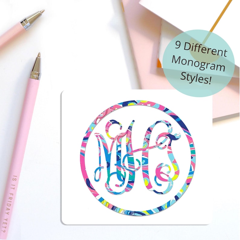 May include: A square coaster featuring a circular frame and a central monogram with the letters M, H, and G, all decorated in a vibrant, multi-colored abstract pattern of pink, blue, yellow, and white. A teal circle contains the text 9 Different Monogram Styles!