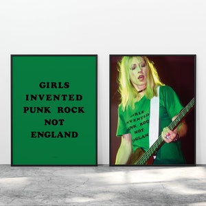 May include: Two framed prints, one with a green background and the text "GIRLS INVENTED PUNK ROCK NOT ENGLAND" in black, and the other with a photo of a woman playing a bass guitar, wearing a green shirt with the same text.