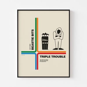 May include: A framed poster with a cream background features the text "BEASTIE BITS JULY 2003" and "TRIPLE TROUBLE" in black. The poster has a graphic of three figures and colourful lines in green, orange, blue, and red.