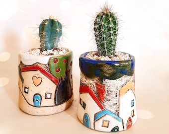 One small random ceramic handmade planter with a view of country houses carved & painted all around. Beautiful home decor and a unique gift