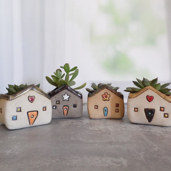 Random ceramic planter shaped as a house or a house decor, made with different kinds of clay and decorations. Plant IS NOT included