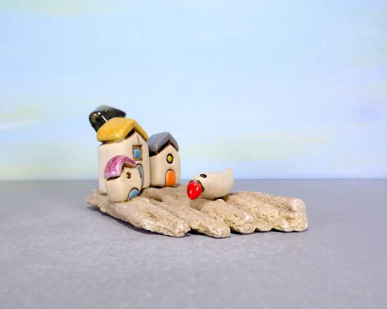 Whimsical white miniature ceramic houses with anOlive tree on a unique beach stone image 9