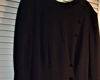 May include: A black long-sleeved dress with a single row of buttons down the side.