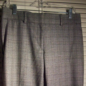 May include: A pair of gray plaid pants with a straight leg.