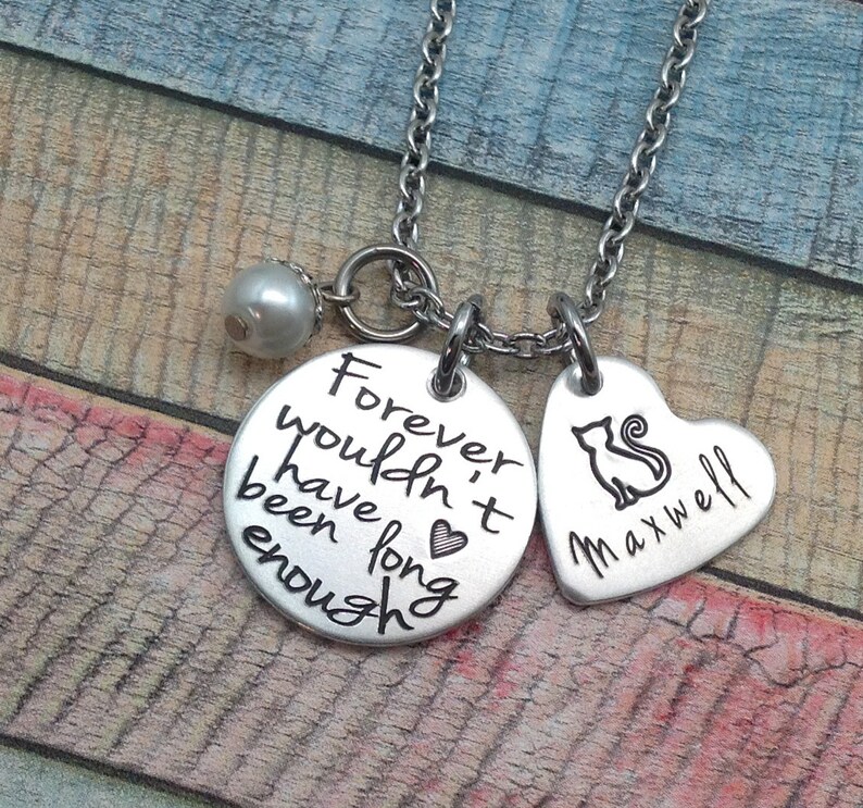 May include: Silver necklace with a heart charm that says "Maxwell" and a round charm that says "Forever wouldn't have been long enough". A small pearl charm hangs from the necklace.