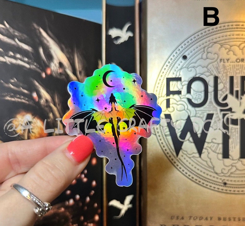 May include: A holographic sticker featuring a rainbow-colored dragon flying in a starry sky with a crescent moon. The sticker is on a white background.