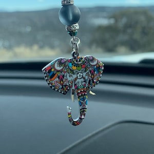 May include: A colorful, patterned elephant charm hangs from a beaded chain with a dark gray glass bead. The charm is a popular symbol of good luck and fortune.