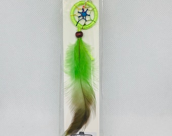 May include: Green dreamcatcher car charm with a green feather hanging from it. The charm has a beaded loop and the text "Car Charm" and "Give Your Car Some Style".