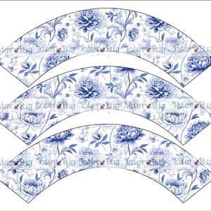 May include: Three blue and white cupcake wrappers with a floral pattern. The wrappers are shaped like a half-circle and have a scalloped edge.