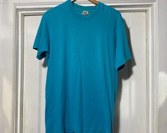 May include: A turquoise blue short-sleeved t-shirt with a crew neck.