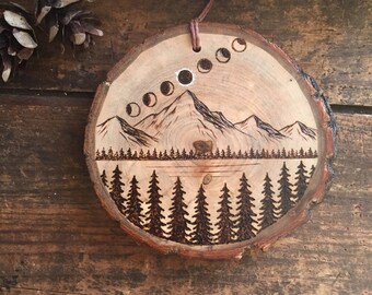 Wood burned mountain scene with 7 phases of total eclipse. Wood slice ornament. PREORDER