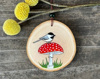 Chickadee on red amanita mushroom wood slice ornament. Handmade by Forage Workshop