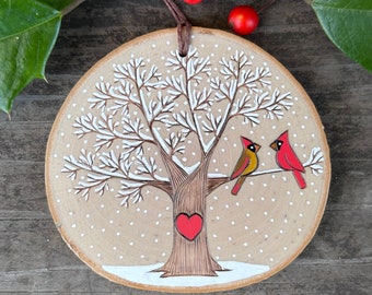 Snowy, winter tree with red cardinal couple and heart. Custom made, personalized wood slice ornament. Handmade by Forage Workshop PREORDER