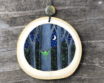 Early summer evening scene with Luna moth, fireflies, trees and starry sky. Wood slice ornament. Handmade by Forage Workshop PREORDER