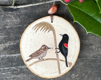 Red winged blackbird couple on a wood slice . Hand painted and wood burned ornament. Handmade by Forage Workshop PREORDER