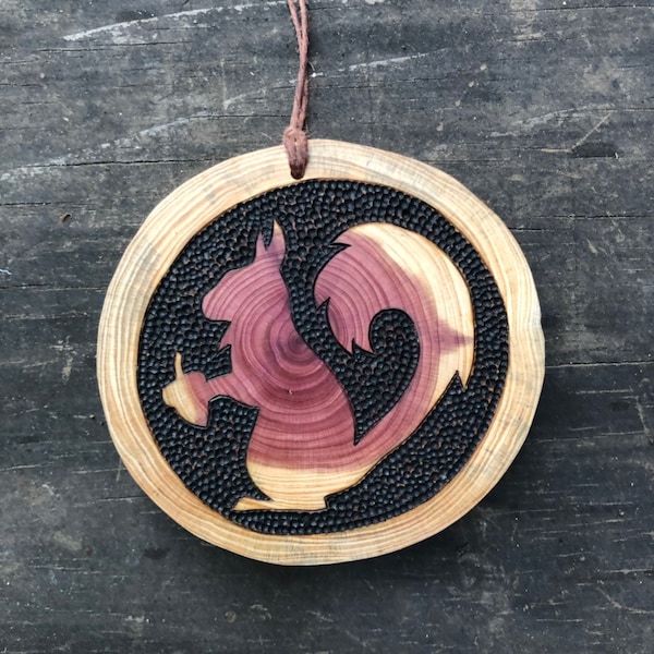 Squirrel ornament. Cedar wood slice wood burned squirrel holding an acorn silhouette. Tracks on ornament back. Handmade by Forage Workshop