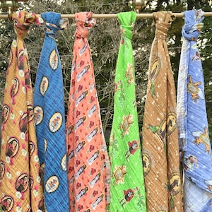 May include: Six colorful baby swaddles with different patterns and designs. The swaddles are made of soft, breathable fabric and are perfect for keeping babies warm and cozy.