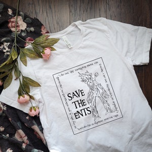 May include: White t-shirt with a black and white graphic of a tree-like creature with the text "Save the Ents" and a quote from the Lord of the Rings book series: "I do not like worrying about such  things.  I am not altogether on my side if you understand me, Creepernd.  Excuse me, I am not altogether on my side."