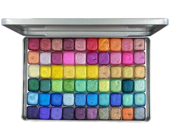 May include: A metal palette with 64 small squares of colorful paint. The squares are arranged in rows and columns, with each row featuring a different color gradient. The palette is open and ready for use.