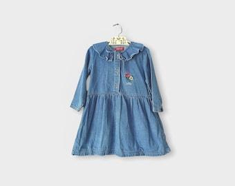 May include: A light blue denim dress with long sleeves and a frilled collar. The dress features floral embroidery and the brand name "Esprit". It is buttoned down the front and has a gathered skirt, hanging on a vintage hanger.