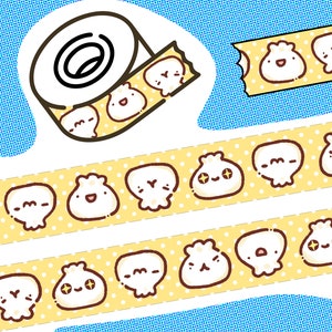 May include: A roll of decorative washi tape featuring a repeating pattern of cartoon dumplings with various expressions. The tape is yellow with white polka dots. The background is a light blue with a dotted pattern.