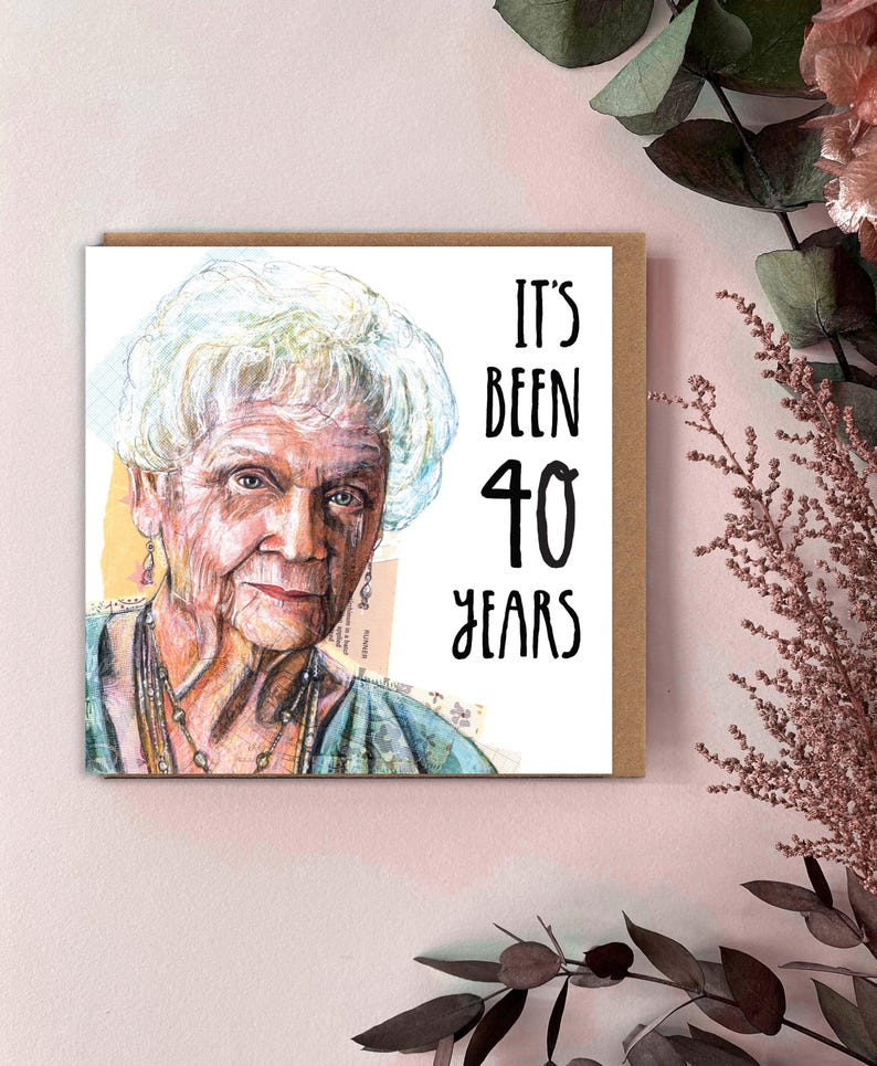 May include: A birthday card featuring a watercolour portrait of an elderly woman with white hair. The card reads "IT'S BEEN 40 YEARS" in black text. The card is on a brown background.
