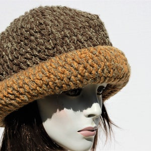 May include: A brown and orange crocheted hat with a wide brim.