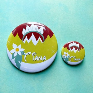May include: Two round buttons with a yellow, red, and white design. The larger button has the word "Tiana" printed on it. The smaller button has the same design but is smaller and has the word "Tiana" printed on it.