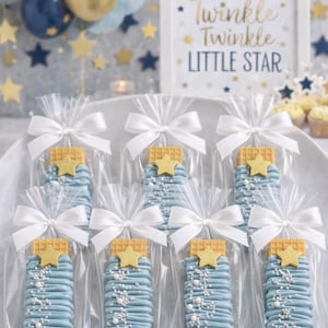 May include: A white ceramic mug with a black handle and the text "But First, Coffee" in a bold, black font. The mug is set against a blurred background, suggesting a cozy setting. The mug appears to be approximately 4 inches tall.