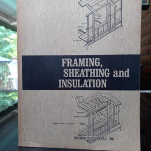 May include: A vintage book cover with a woodgrain background. The title is "Framing, Sheathing and Insulation" with illustrations of a house frame and roof construction.